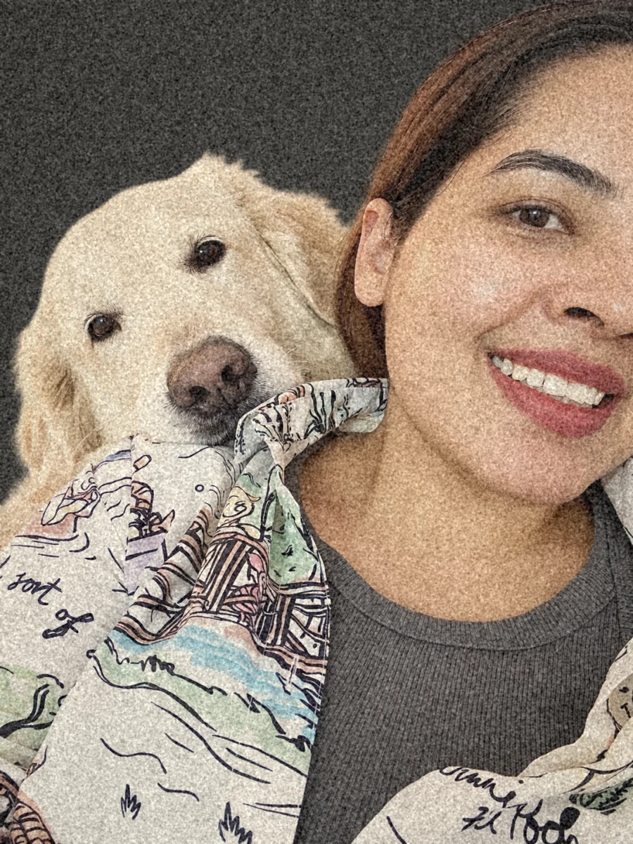 Gayathri on the sofa, her English cream retriever resting its chin on her shoulder